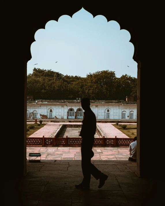 the silhouette of a man is walking outside