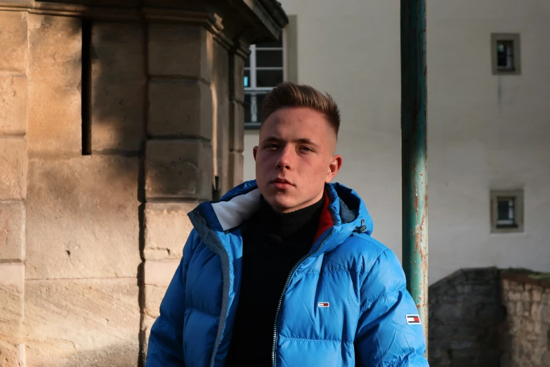 man wearing a blue coat looking off into the distance