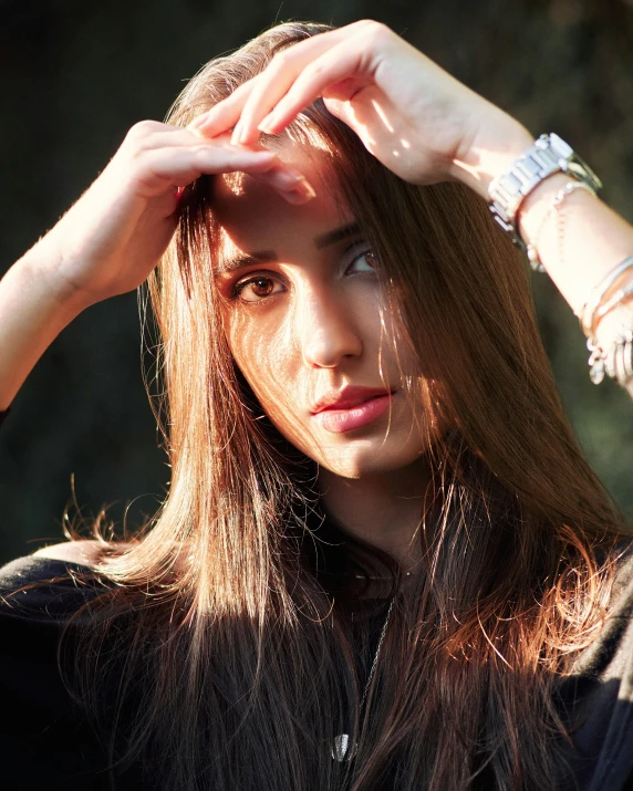 a woman is holding her head down with both hands