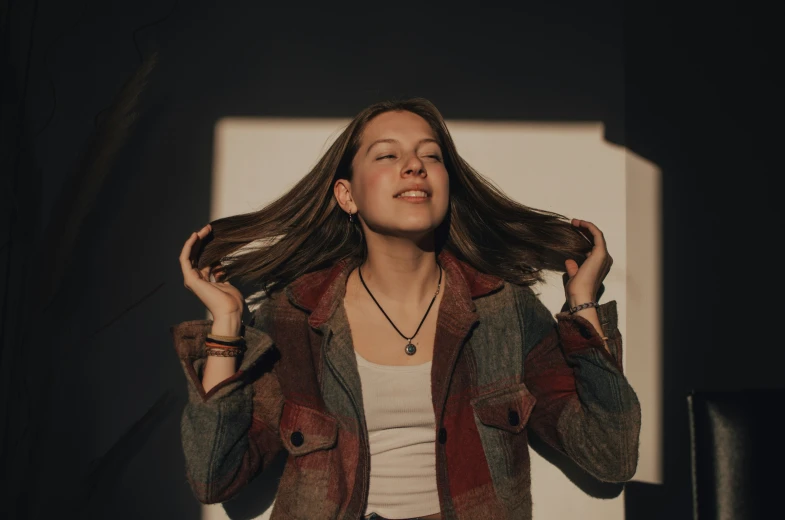 a woman with long hair standing in the dark