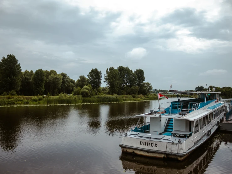 three boats in the water next to a bridge