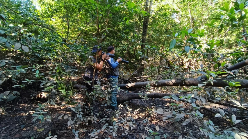 a couple of people that are standing in the forest