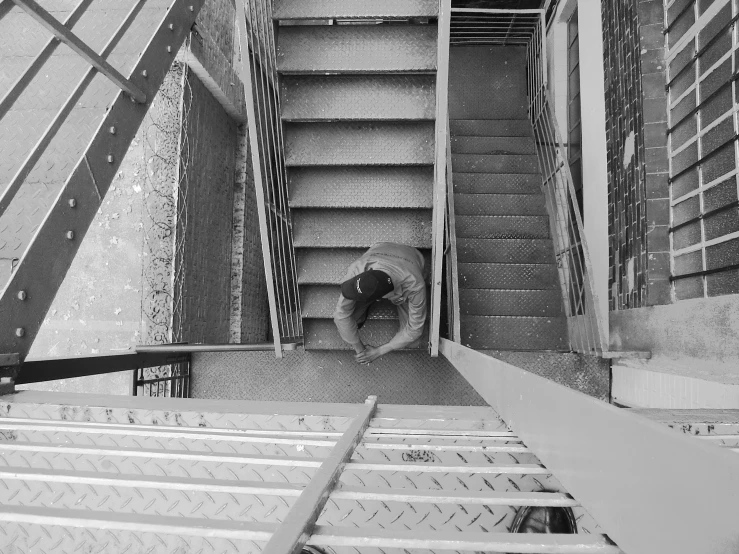 a black and white po of someone going up an escalator