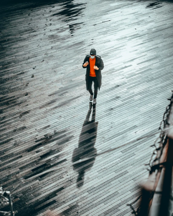 a person walking in the rain in the distance