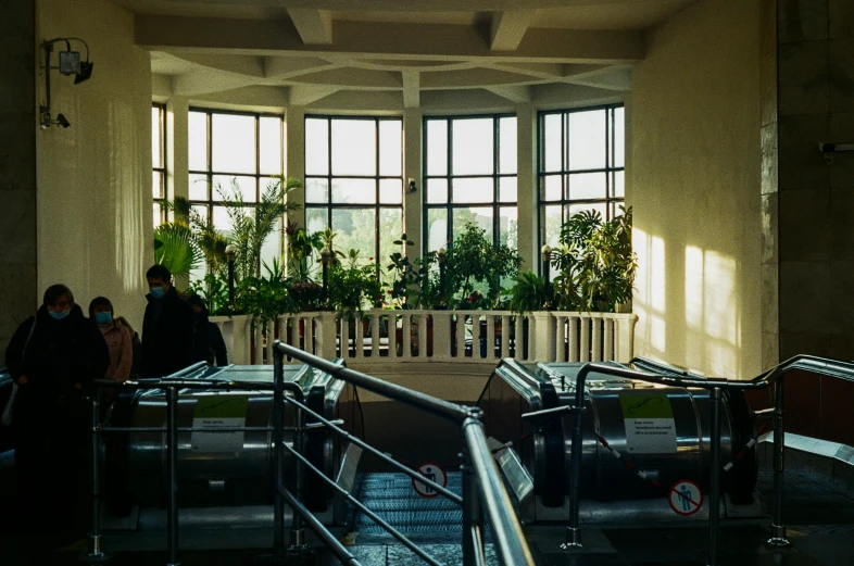 two people walking up stairs with a large window