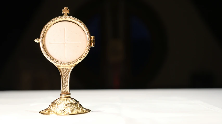 a gold mirror sitting on top of a white table