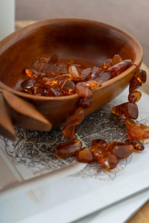 pieces of a broken cereal sit in a wooden bowl