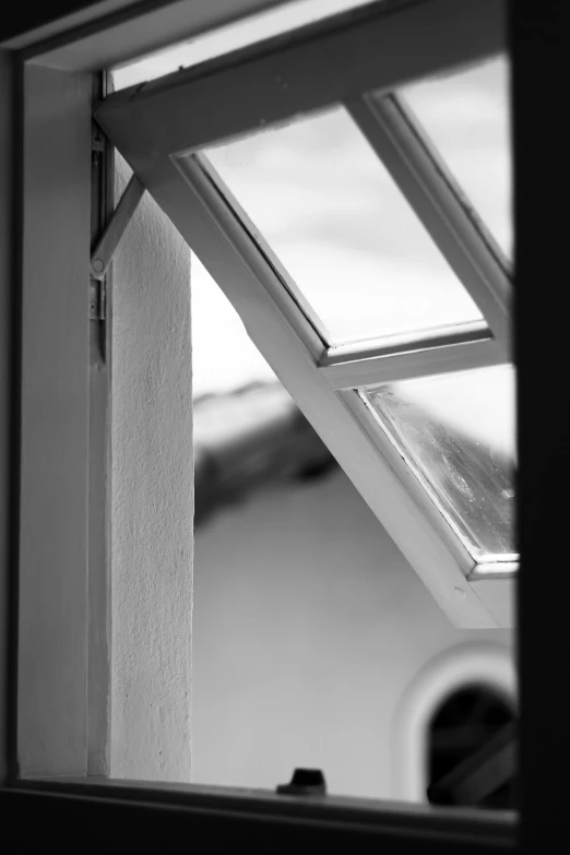 an open window with a view of a house roof