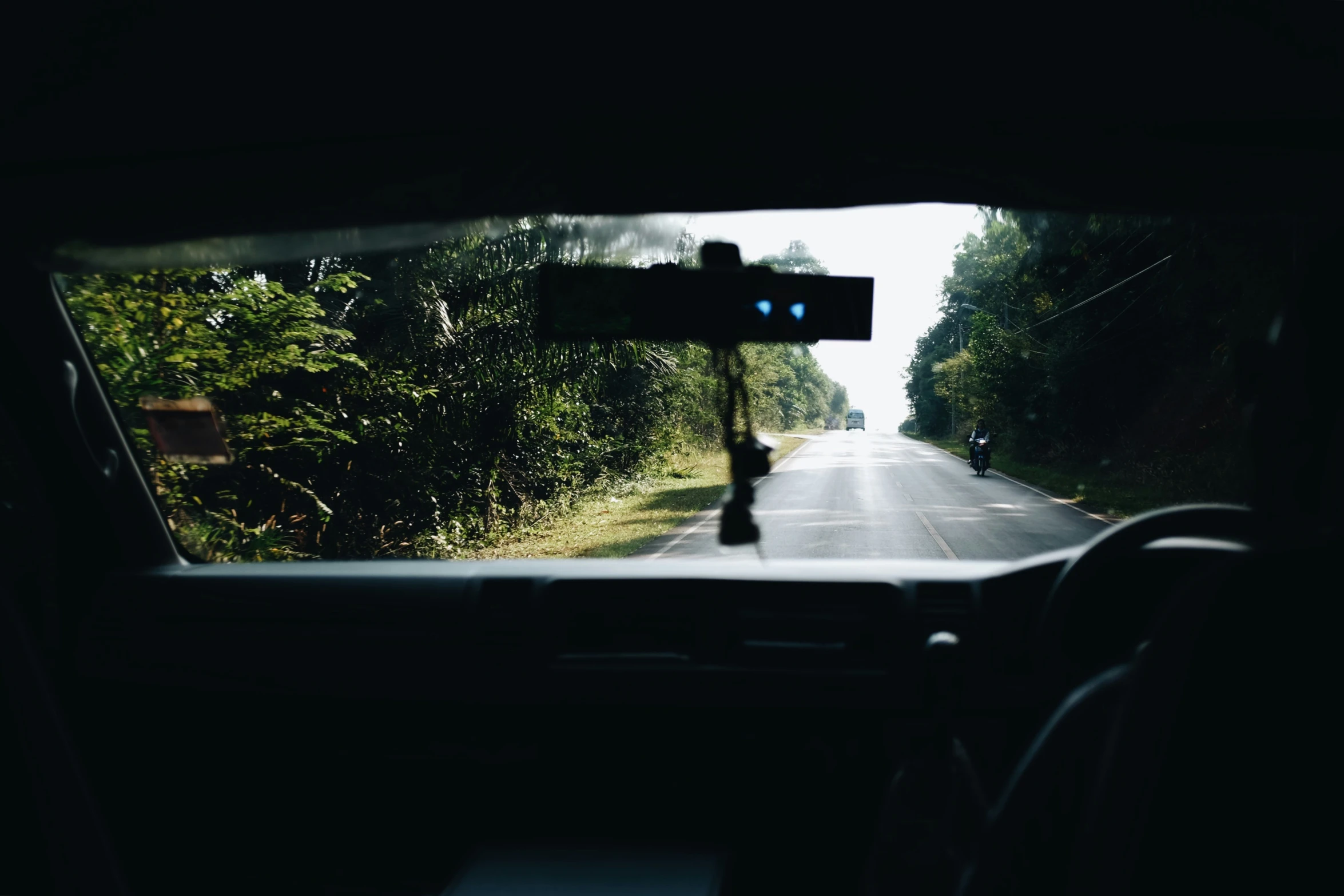 the view from inside the car shows an approaching camera