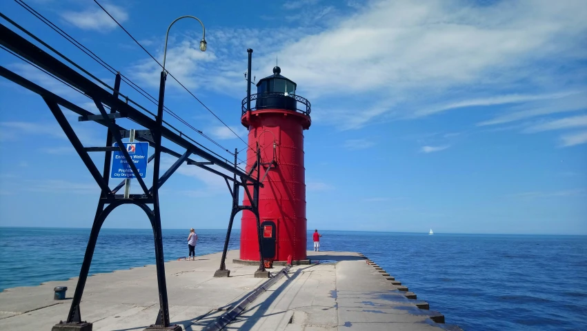 a person on a bike near a lighthouse