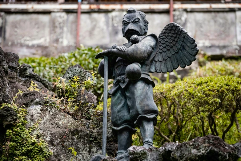 the statue depicts an angel holding a spear