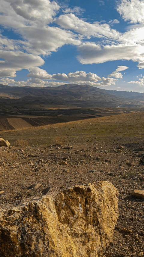 a po of a rock out in a dirt field