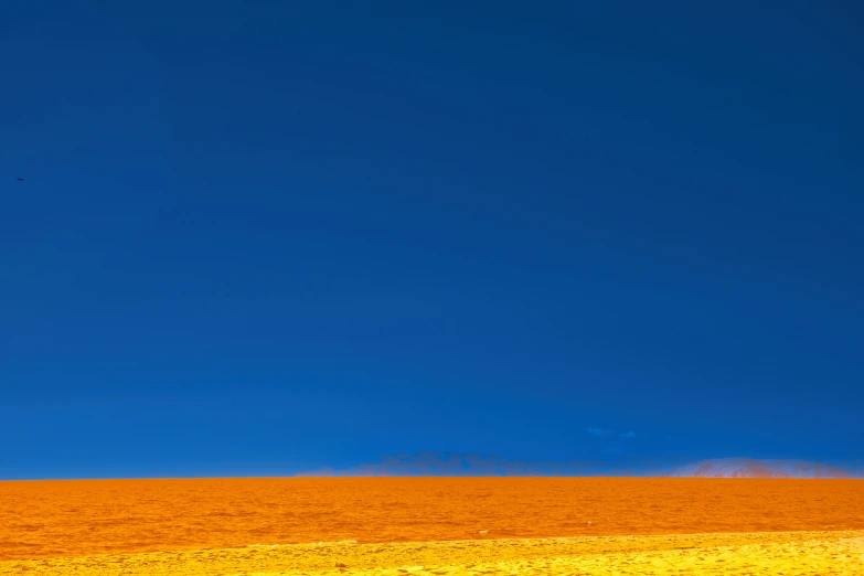 a field with an orange substance that looks like a dust storm