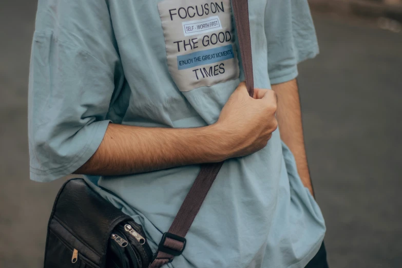 a man standing while holding onto a bag