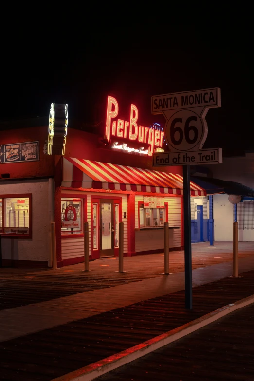 a small restaurant with neon sign at night