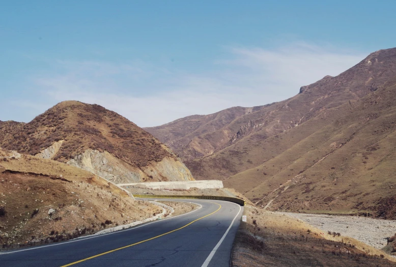 a scenic road on a mountain side in the middle of nowhere