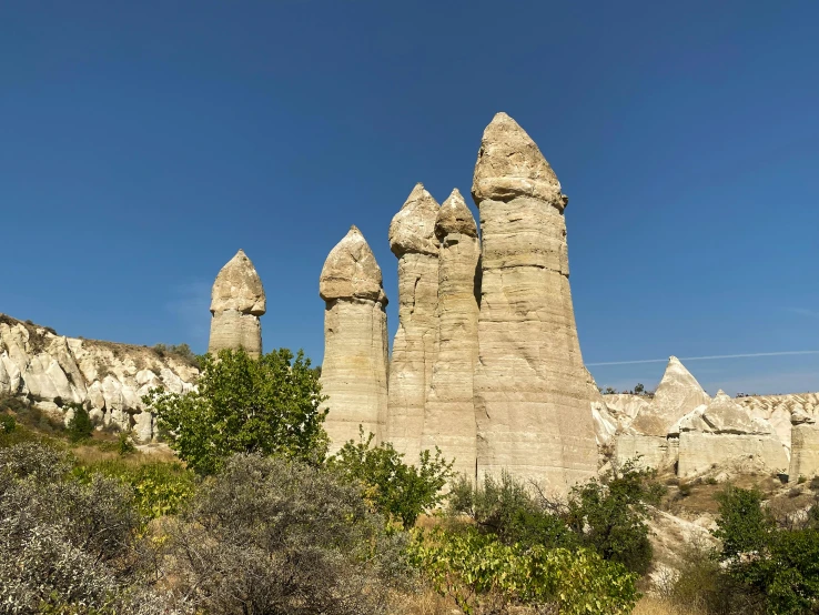 some very tall rock formations near the trees