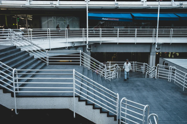 the view of an outdoor plaza with stairs, railings, and a staircase