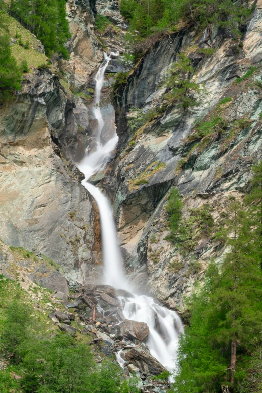 a couple of small waterfalls with trees surrounding