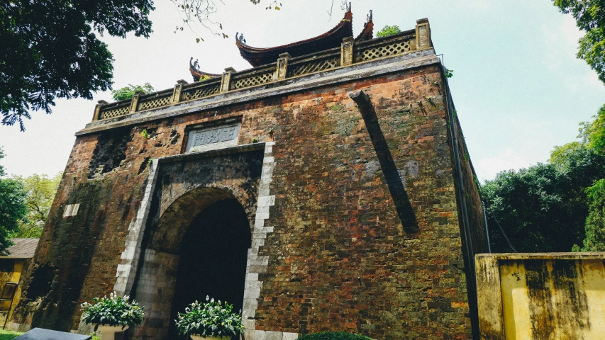 a large old building in front of some trees