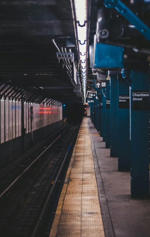 a long train traveling down tracks near a station