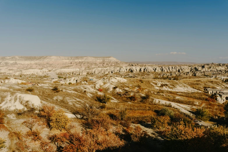 a large grassy valley on the edge of an arid landscape