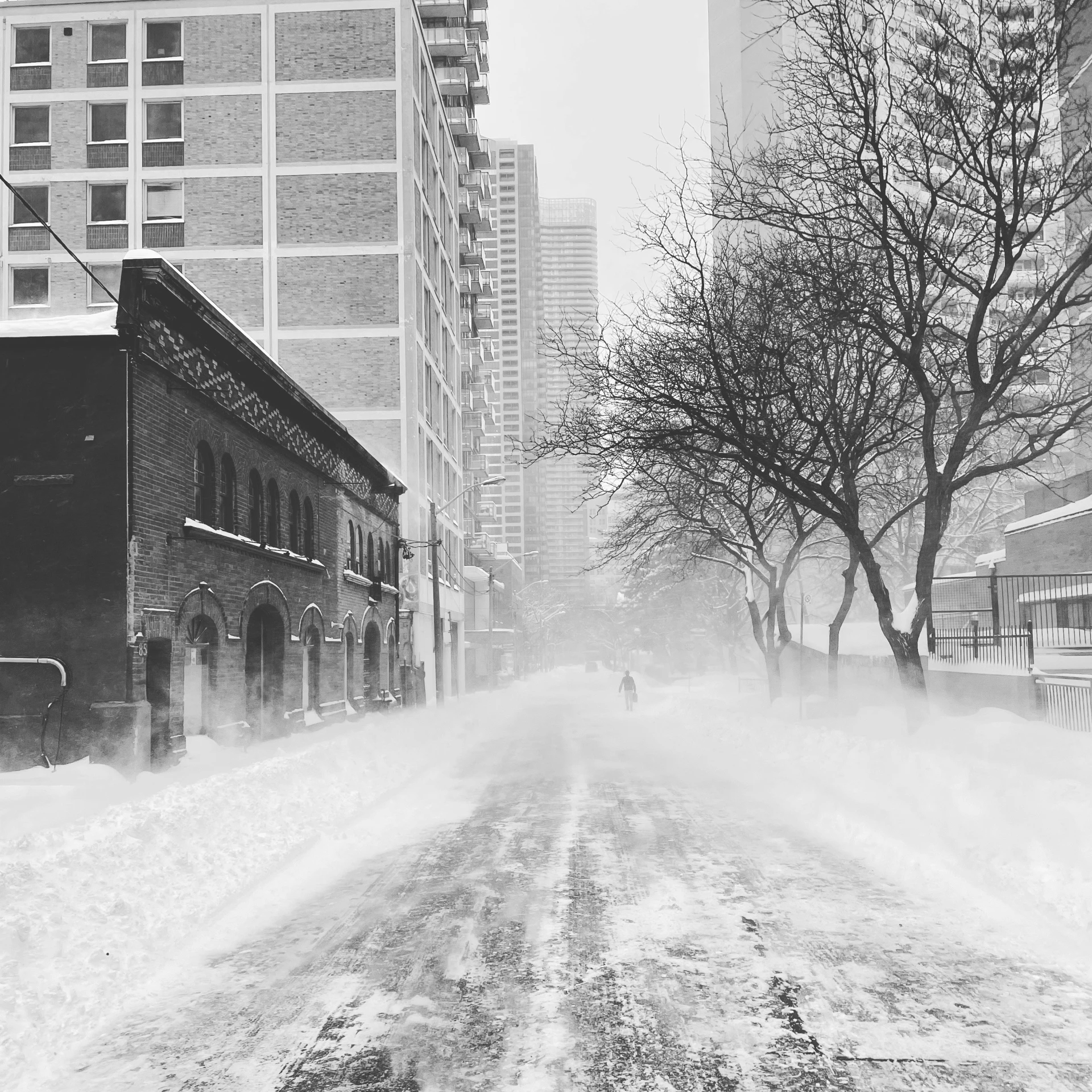 a person walking across a snow covered street