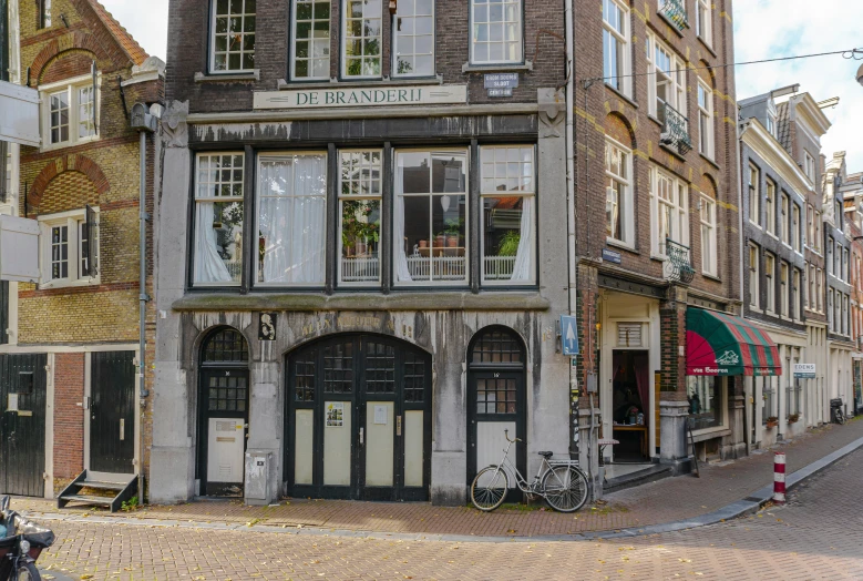 a small old building sits on a street