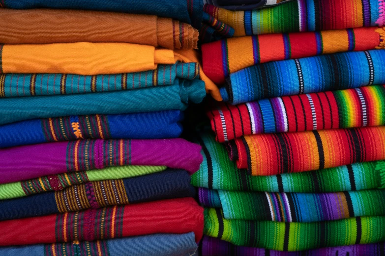 several rows of towels folded in a large rainbow color