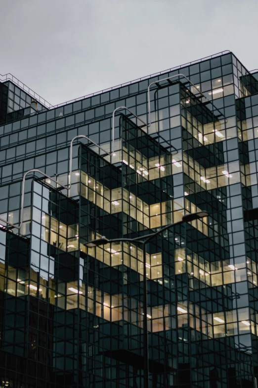 a very tall, modern building with windows lit up at night