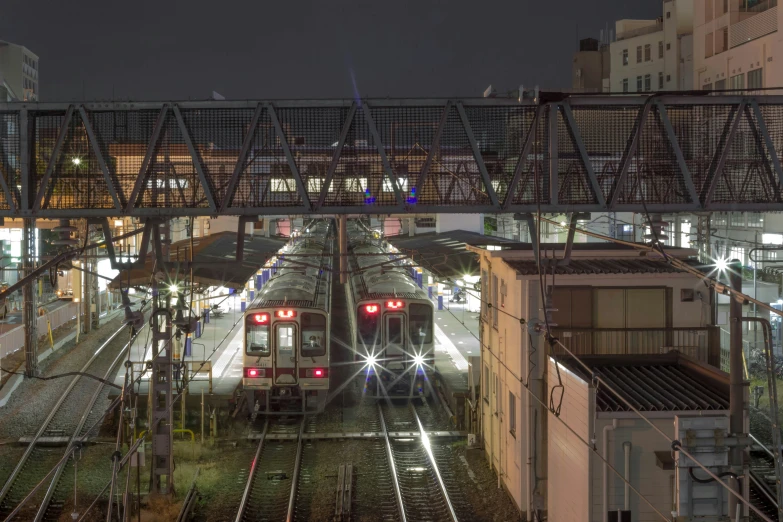 train at station with its lights on and red