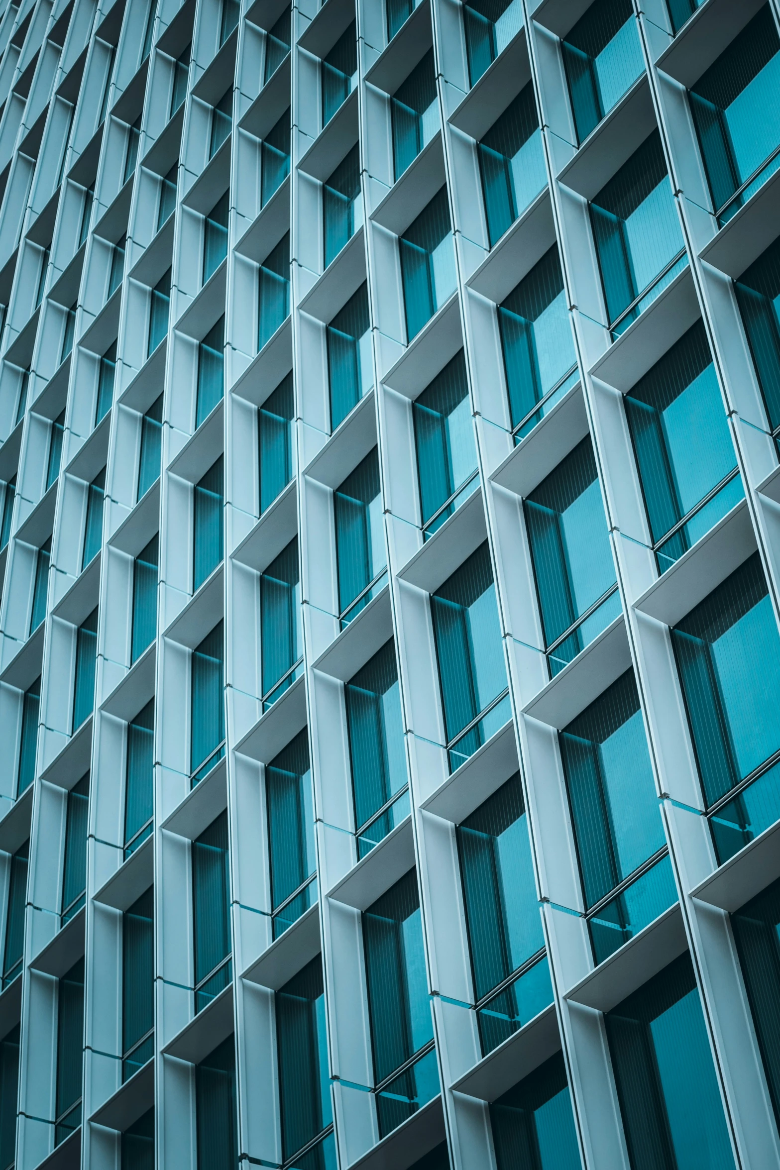 an architectural building has blue windows and balconies