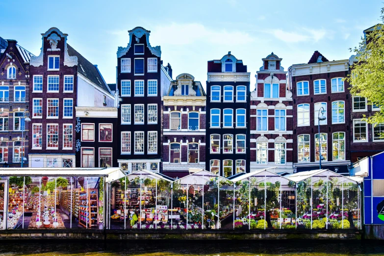 many buildings near a river with blue sky