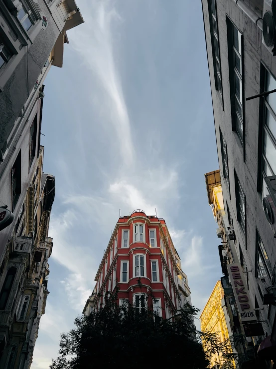 the top of two buildings stand between another building