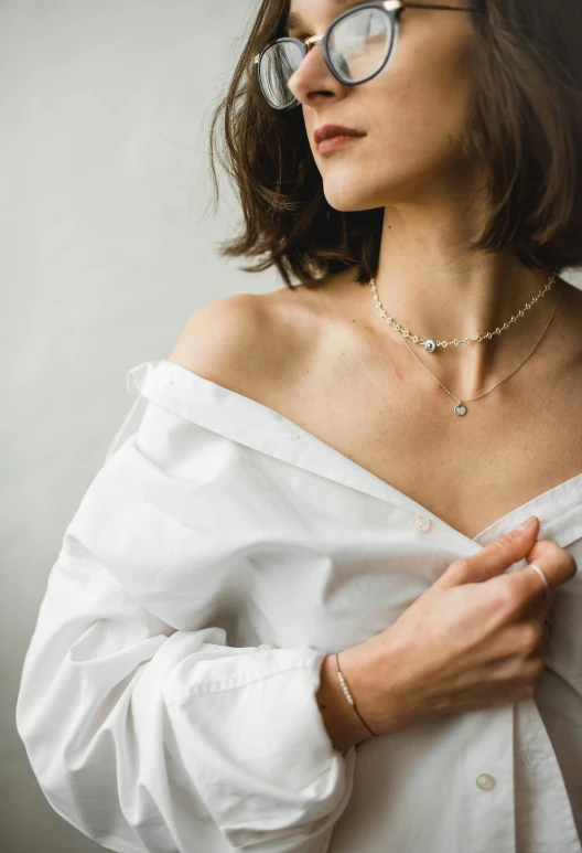 a close - up po of a woman wearing a white shirt and glasses