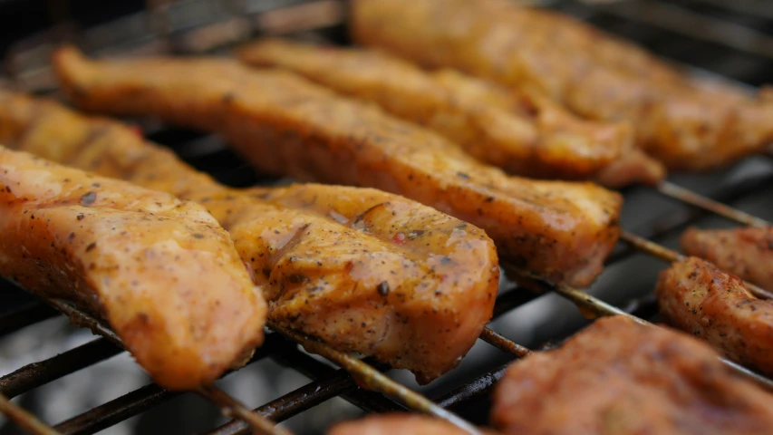 some meats and potatoes on a grill