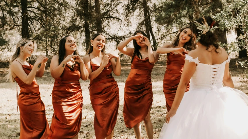 a group of young women standing in the woods