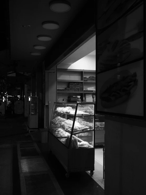 a bakery display in the corner of a dark room