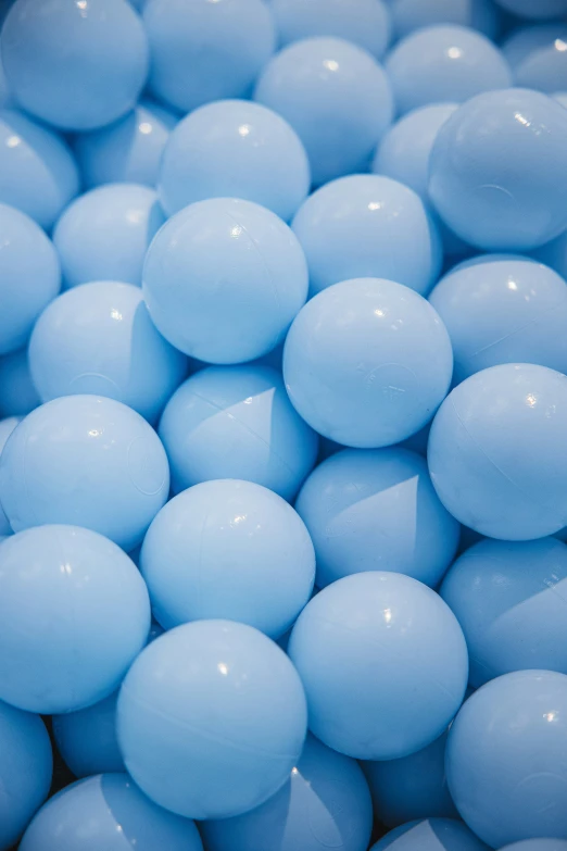a bunch of blue candy balls are closeup