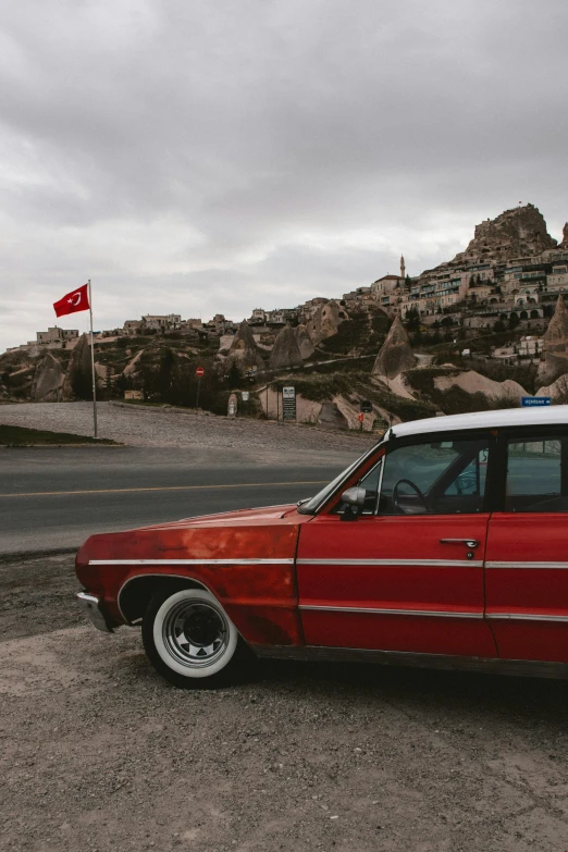 an old car with a small flag on top of it