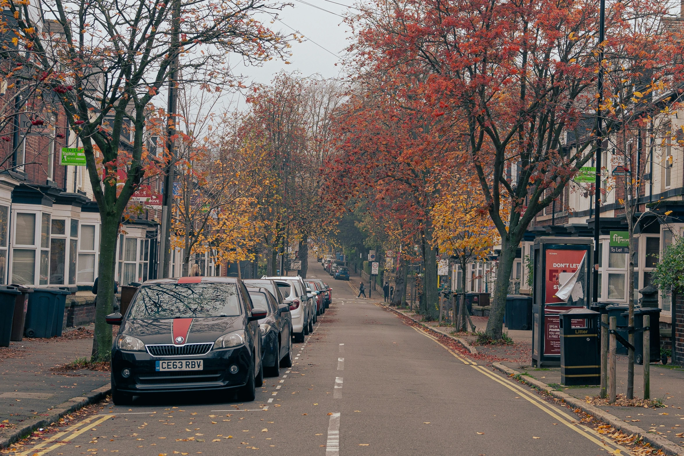 cars parked on the side of the road between two sides