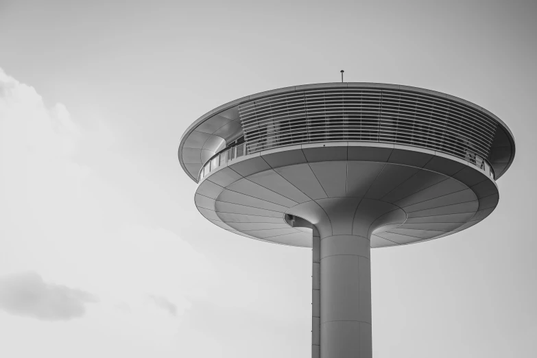 a tall tower that is under a cloudy sky