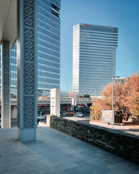 a tall building sitting in the middle of a park next to a river