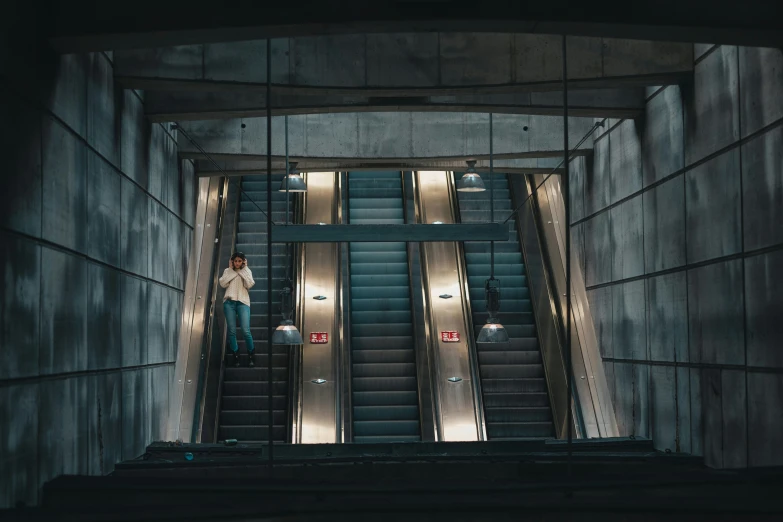 people walking up and down an escalator, near metal doors