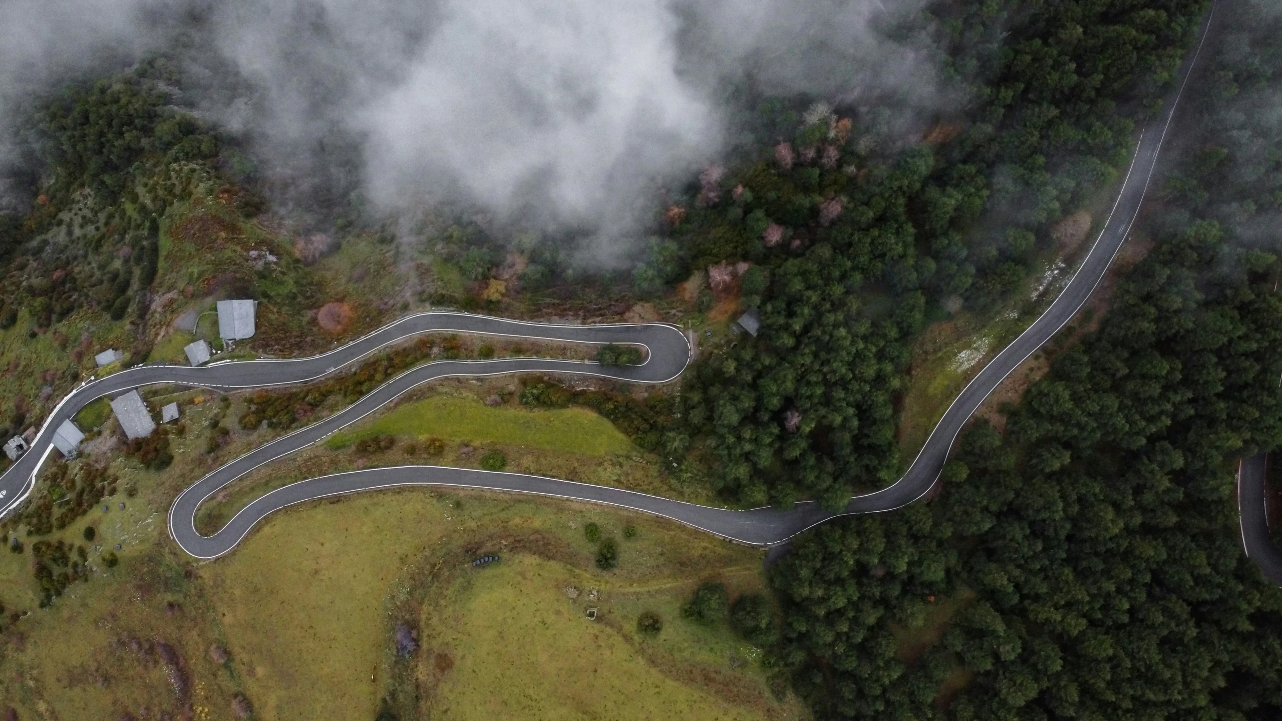 an aerial view of two road sections with a winding one way street, taken from the air