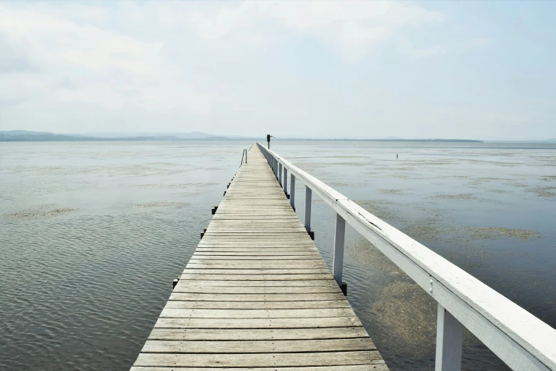 the dock extends out to the water and the sky