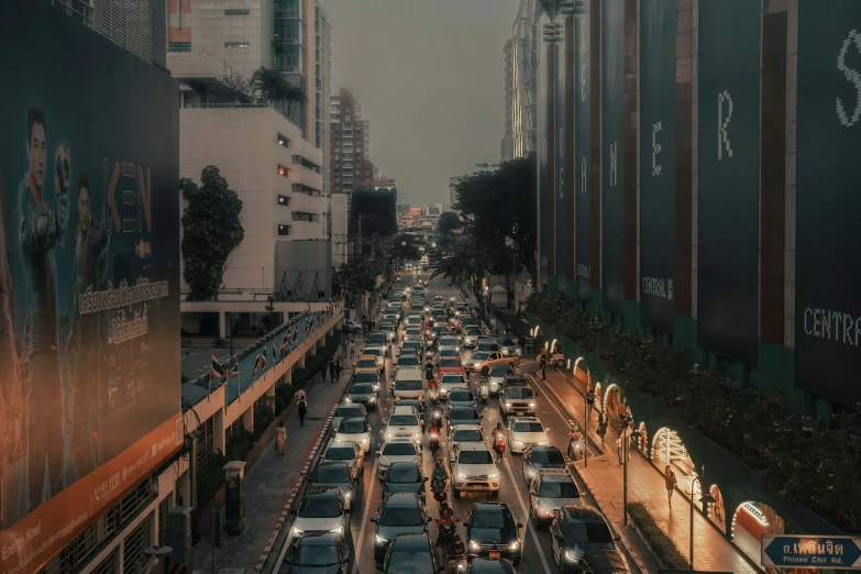 a busy street is lined with many parked cars