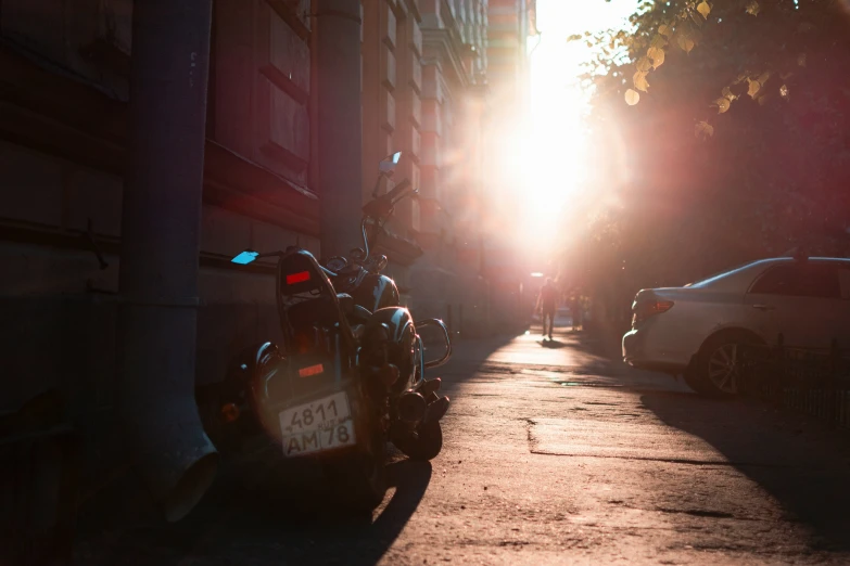 the sun is shining through a very long narrow street