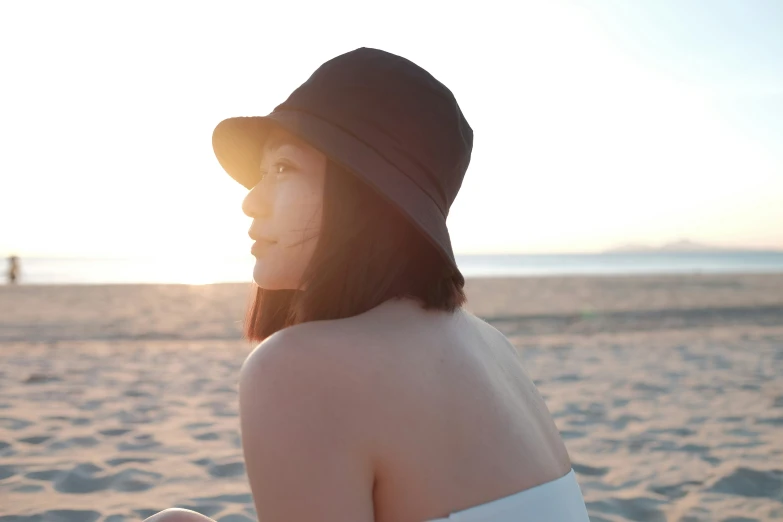 a woman standing in the sand on a beach