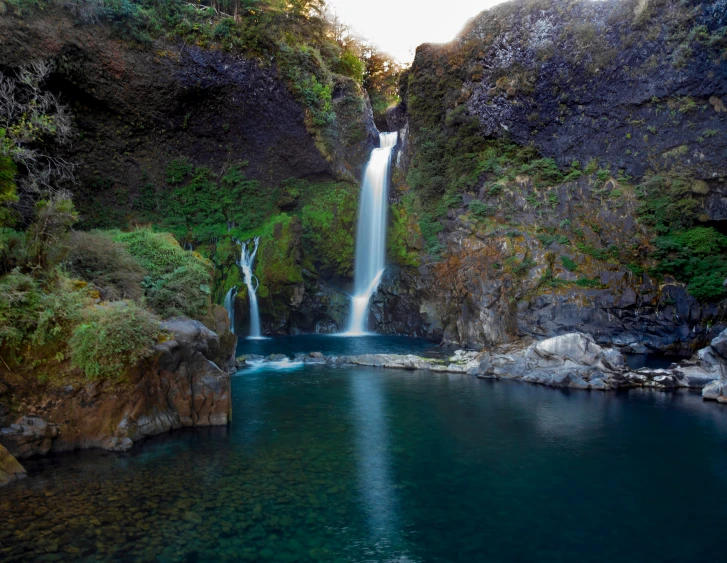 there is a waterfall in the middle of the water